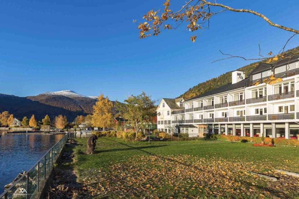 Scenic view of Hornindals Lake, Europe’s deepest lake, surrounded by lush greenery, as seen from Raftevold Hotel