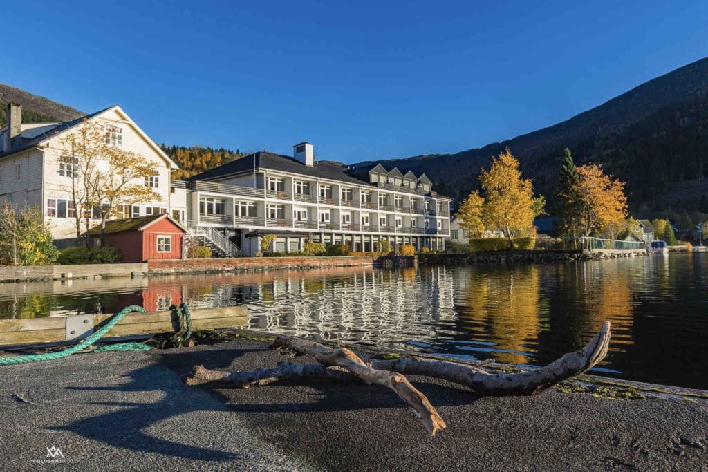 Scenic view of Hornindals Lake, Europe’s deepest lake, surrounded by lush greenery, as seen from Raftevold Hotel