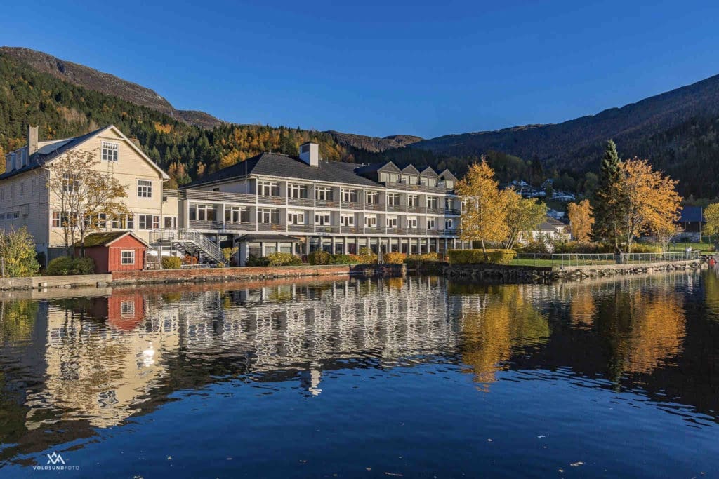 Scenic view of Hornindals Lake, Europe’s deepest lake, surrounded by lush greenery, as seen from Raftevold Hotel