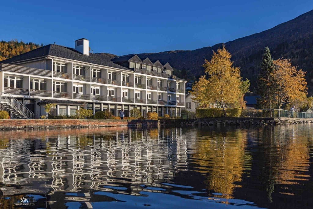 Scenic view of Hornindals Lake, Europe’s deepest lake, surrounded by lush greenery, as seen from Raftevold Hotel.
